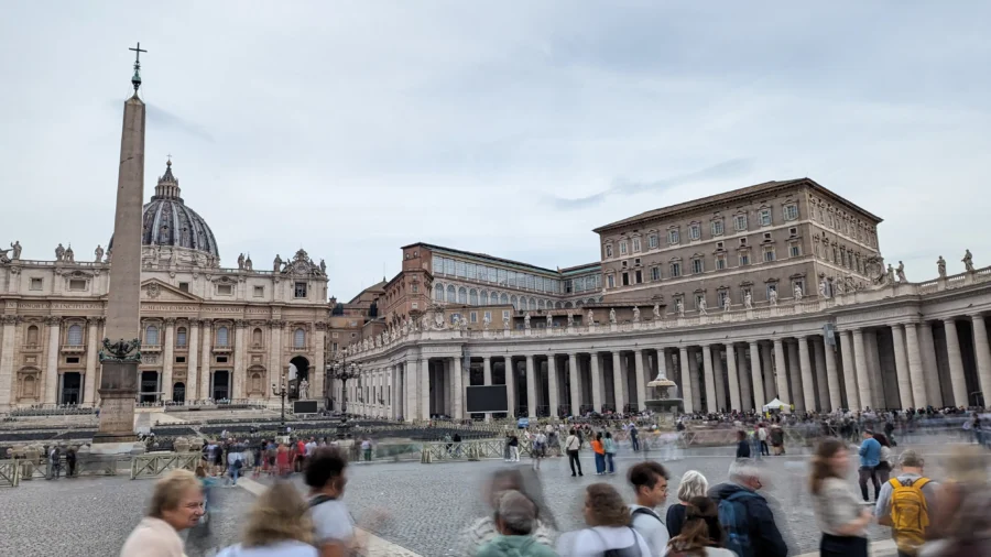 Rome Destination Guide: How to roam when in Rome 10 Crowded Vatican City square with architecture.
